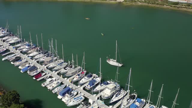 Aerial view of the harbor, boats and the bay in Point Loma, with paddlers on the water.