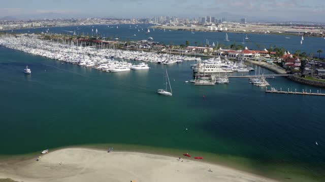 Aerial view of the harbor, the skyline and boats in Point Loma, with boats out.