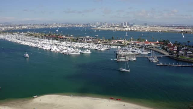 Aerial view of the harbor, the skyline and boats in Point Loma, with boats out.