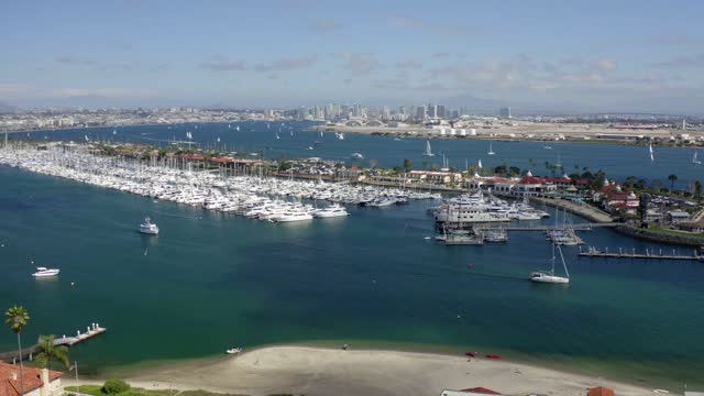 Aerial view of the harbor, the skyline and boats in Point Loma, with boats out.