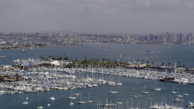 Aerial view of the harbor, the skyline and boats in Point Loma, with boats out.