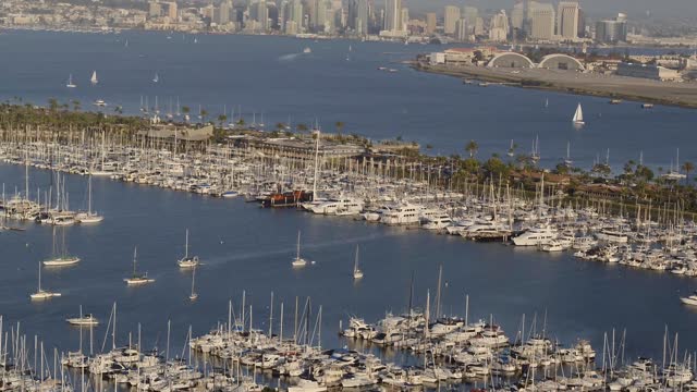 Aerial view of the harbor, the skyline and boats in Point Loma, with boats out.