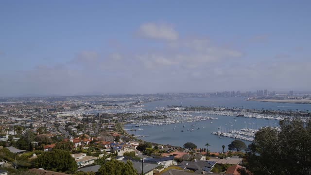 Aerial view of the harbor, the skyline and boats in Point Loma, with boats out.