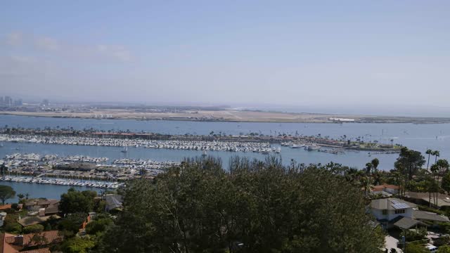 Aerial view of the harbor, the skyline and boats in Point Loma, with boats out.