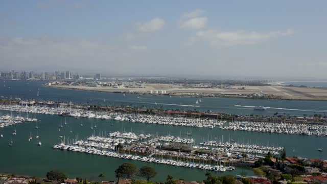 Aerial view of the harbor, the skyline and boats in Point Loma, with boats out.