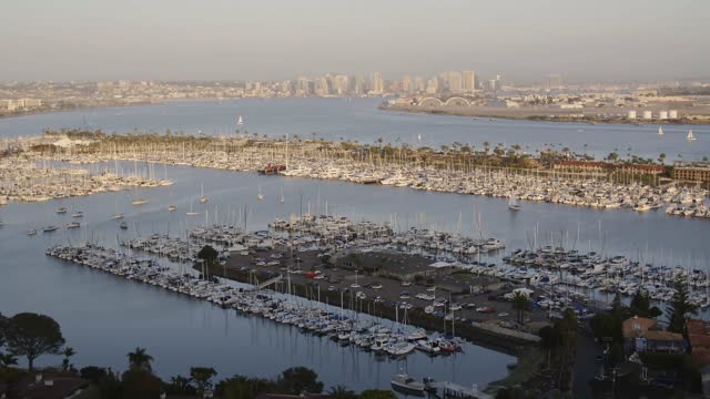 Aerial view of the harbor, the skyline and boats in Point Loma, with boats out.