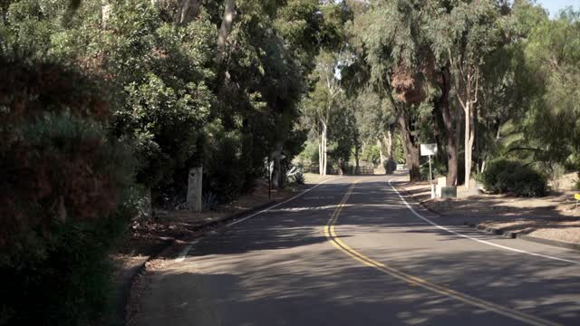 A residential street, traffic and open country in Rancho Santa Fe.