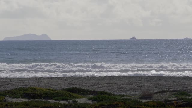 The beach, the surf and boats at Coronado Beach.