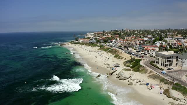 Aerial view of the beach, the surf and the ocean at Windansea, with people walking.