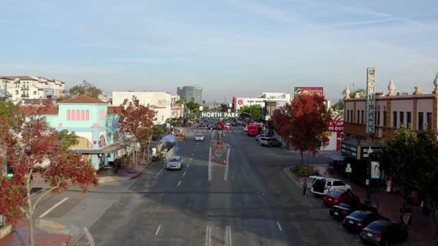 Low aerial view of the downtown streets, the buildings and the city in North Park, with people walking.