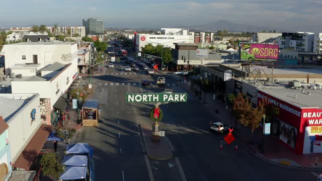 Low aerial view of the downtown streets, the skyline and the buildings in North Park, with people walking.