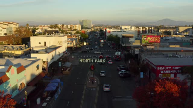 Low aerial view of the downtown streets, the skyline and the buildings in North Park.