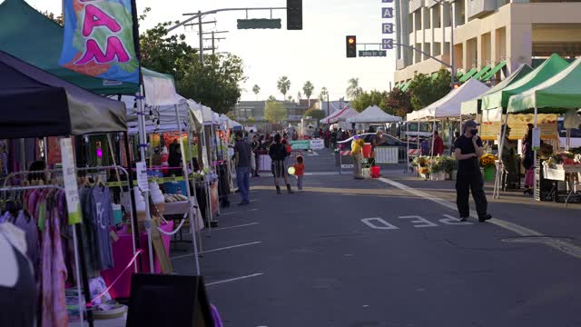 The downtown streets, palm trees and the buildings in North Park, with a crowd gathered.
