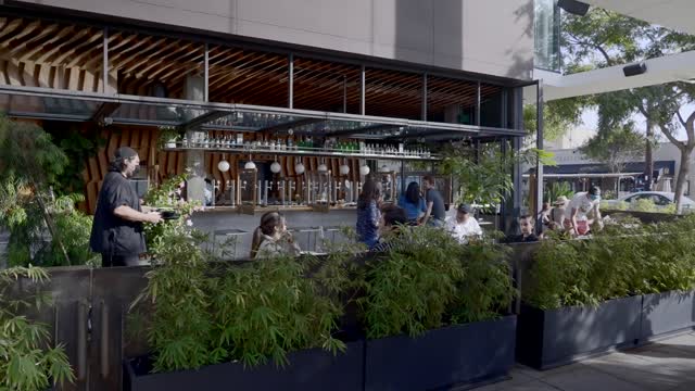 The downtown streets, the buildings and open country in North Park, with people eating outside.