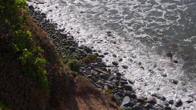 Elevated view of the cliffs, the surf and the ocean at Bird Rock.