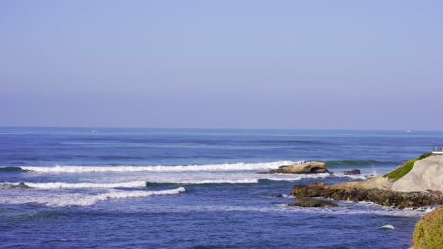 Elevated view of the cliffs, the surf and the ocean at Bird Rock.