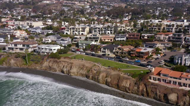Aerial view of a residential street, palm trees and the ocean at Bird Rock, with people walking.