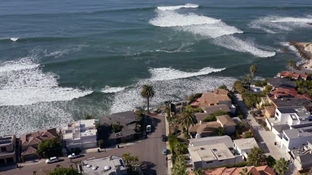 Aerial view of a residential street, the surf and palm trees at Bird Rock.