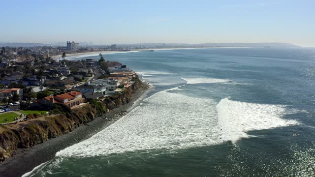 Aerial view of the cliffs, the surf and the pier at Bird Rock.