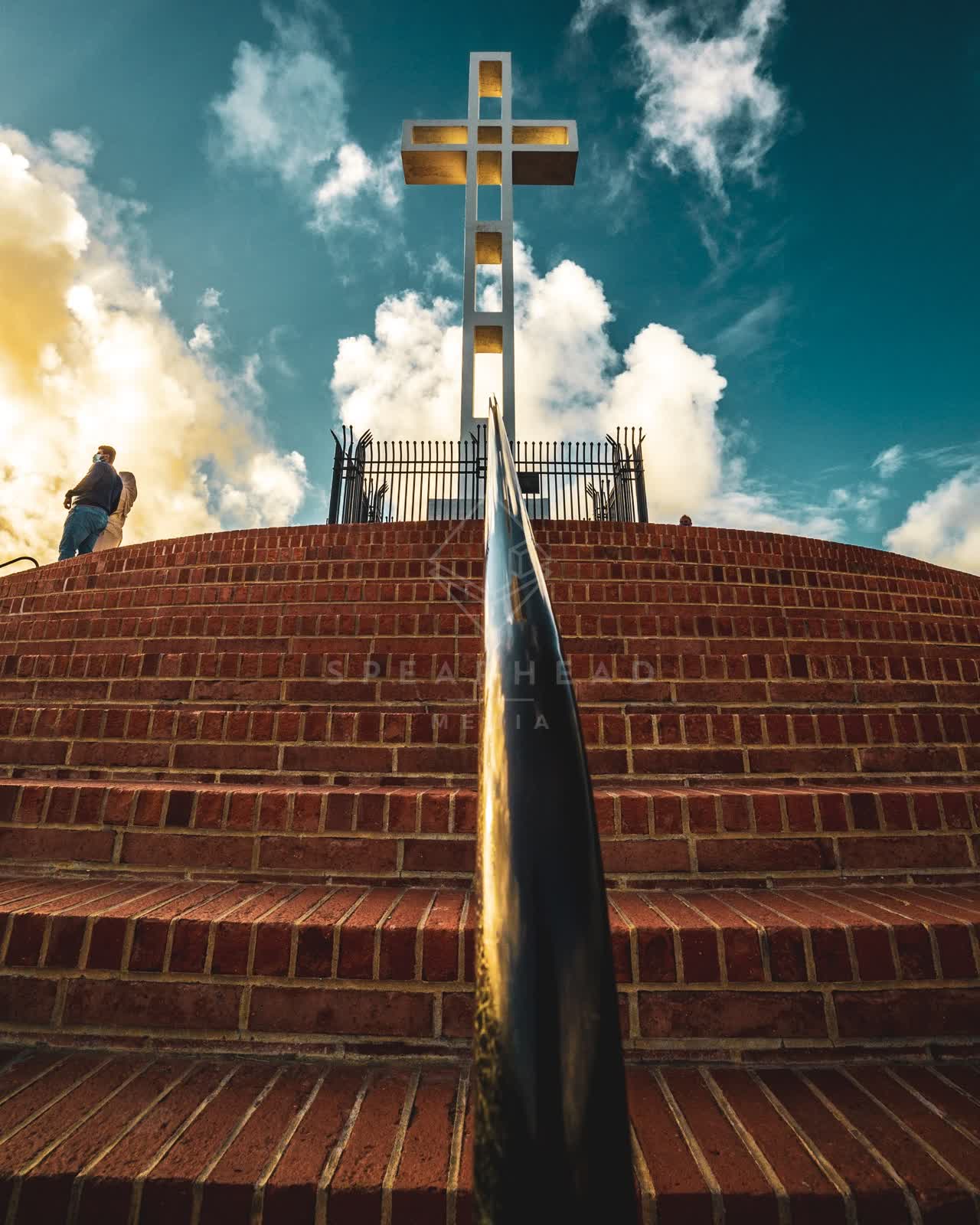 A park, the buildings and open country at Mount Soledad, with people walking.