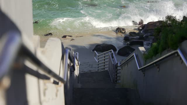 Elevated view of the beach, the surf and the ocean at La Jolla Cove.