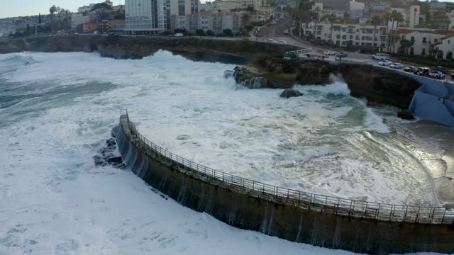 Aerial view of the cliffs, the surf and the ocean at La Jolla Cove.