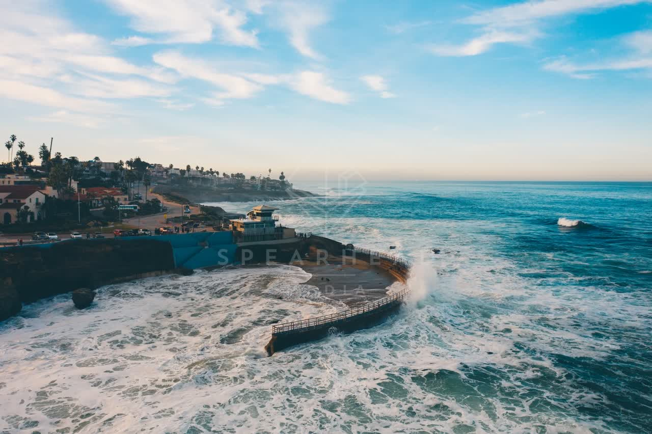 Aerial view of the cliffs, the surf and palm trees at La Jolla Cove.