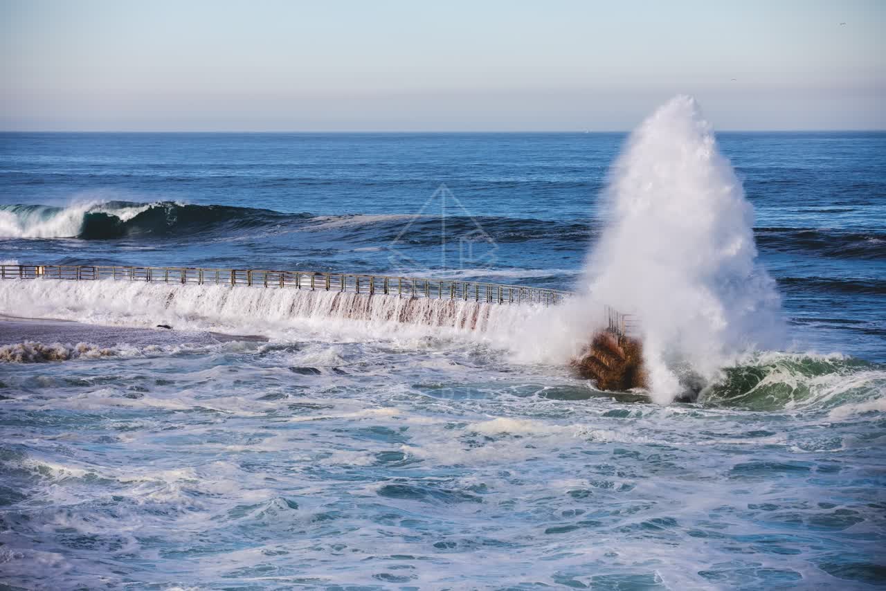 Elevated view of the cliffs, the surf and the ocean at La Jolla Cove.