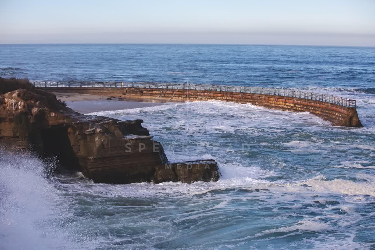 Elevated view of the cliffs, the surf and the ocean at La Jolla Cove.