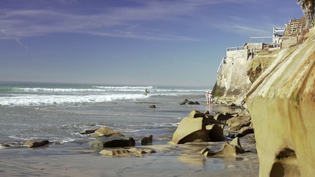 The beach, the surf and the ocean at Leucadia, with surfers out.