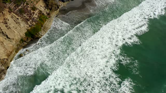 Aerial view of the cliffs, the surf and the ocean at Leucadia.