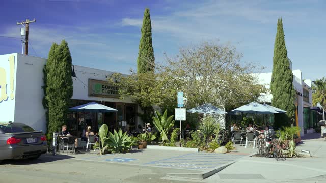 The downtown streets, homes and the buildings at Leucadia, with people eating outside.