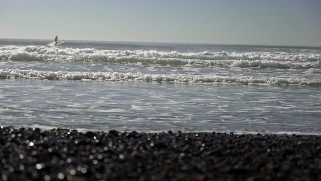 The beach, the surf and the ocean at Leucadia, with surfers out.
