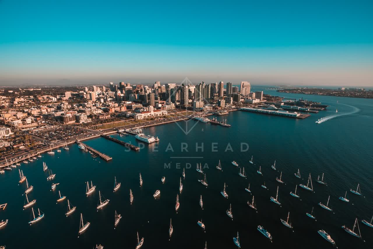 Aerial view of the downtown streets, the skyline and boats at San Diego Marina, with boats out.