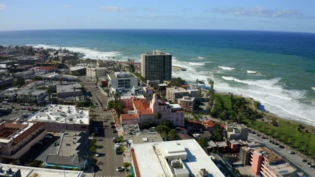 Aerial view of the downtown streets, the surf and palm trees at La Jolla Cove.