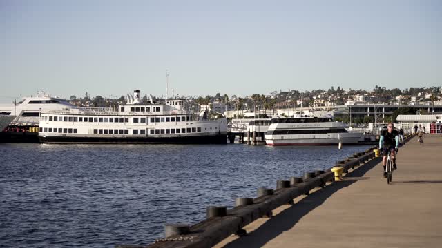 The harbor, boats and the bay at Waterfront, with cyclists riding.