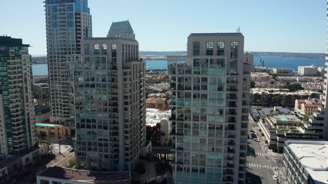 Low aerial view of the downtown streets, the skyline and boats at Marina.