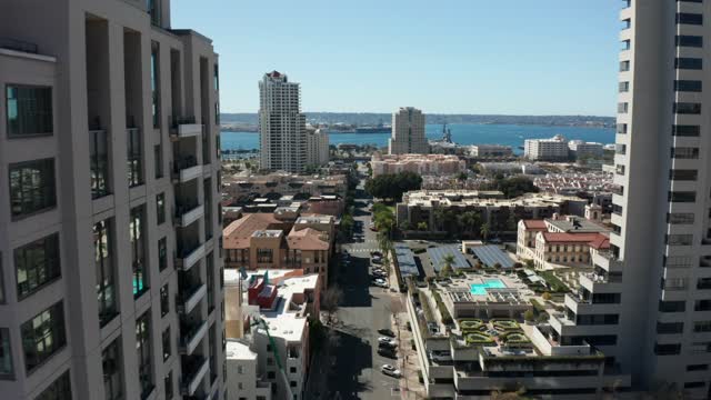 Low aerial view of the downtown streets, the skyline and boats at Marina.