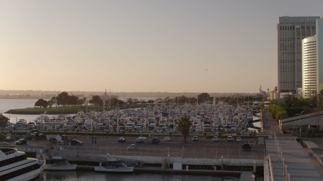 Low aerial view of the harbor, the skyline and boats at Marina, with boats out.