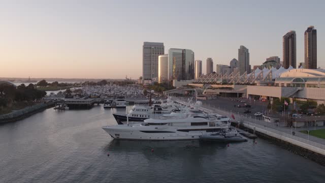 Low aerial view of the harbor, the skyline and boats at Marina, with boats out.