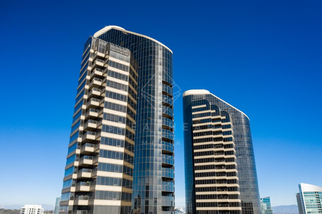 Low aerial view of the downtown streets, the skyline and the buildings at San Diego Marina.