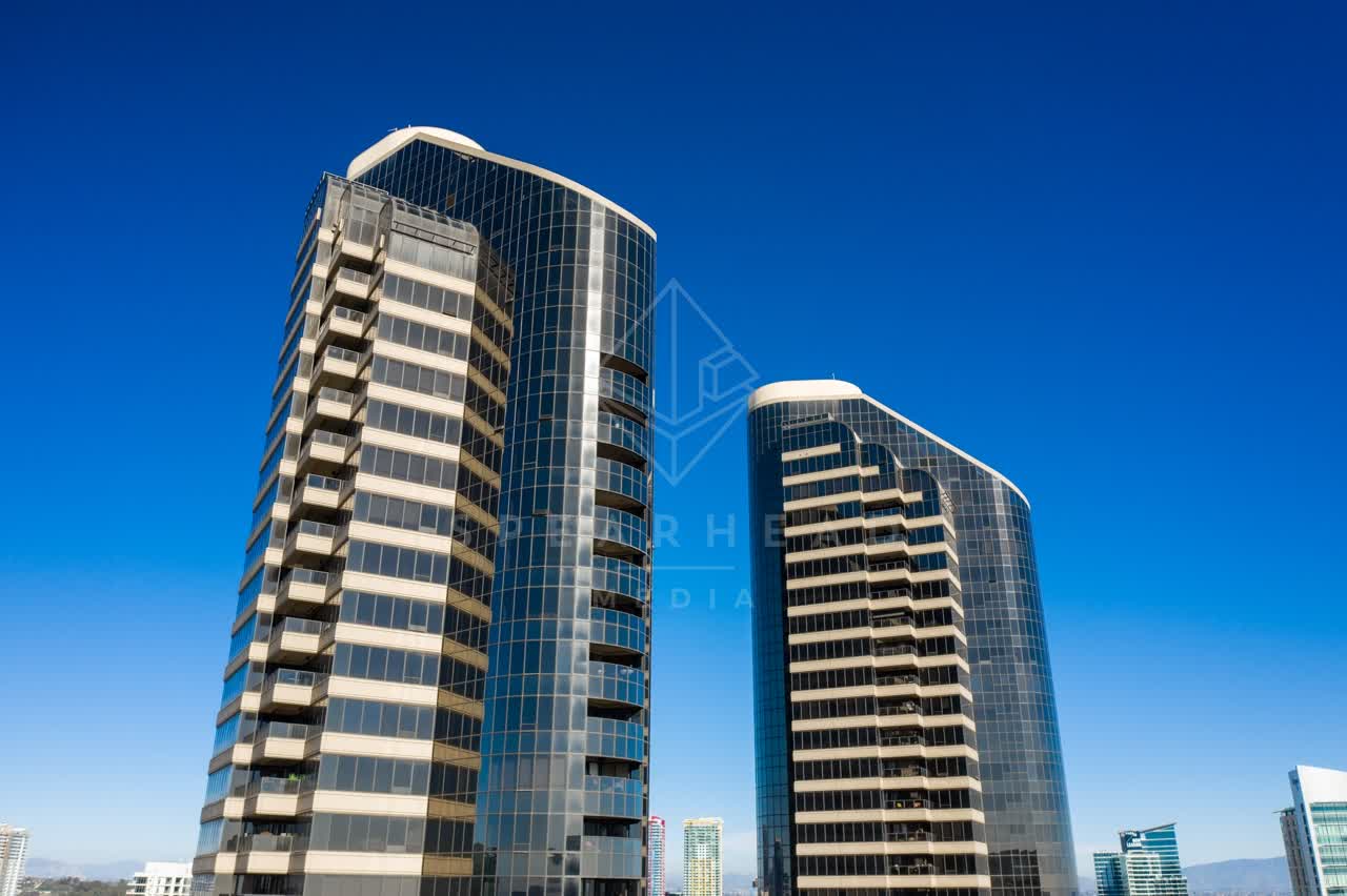 Low aerial view of the downtown streets, the skyline and the buildings at San Diego Marina.
