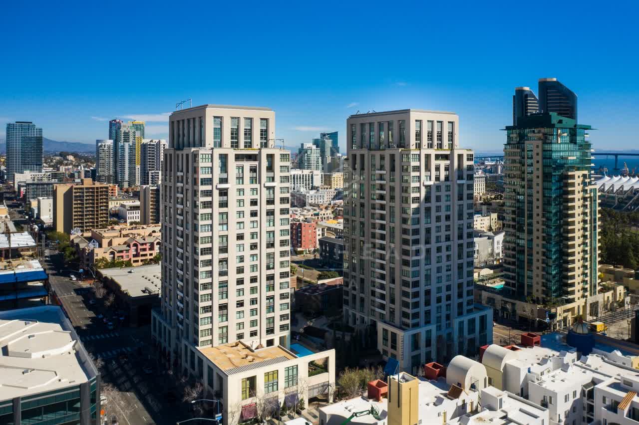 Low aerial view of the downtown streets, the skyline and homes at San Diego Marina.