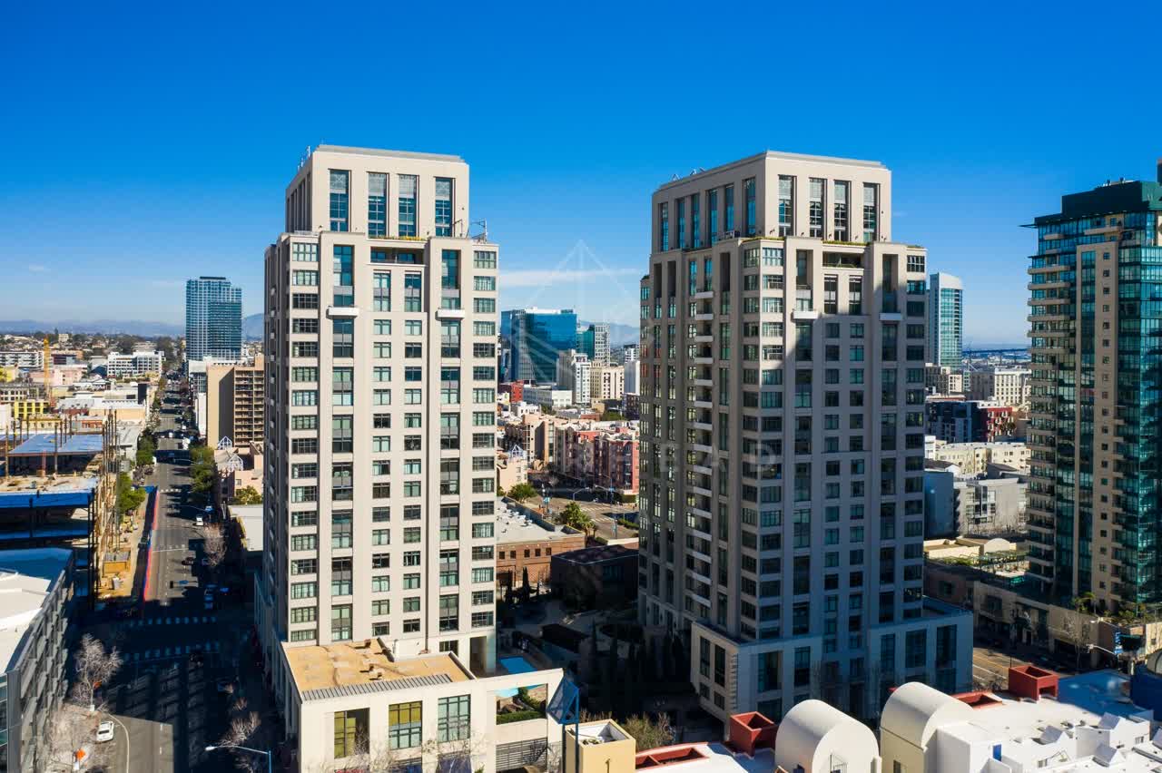 Low aerial view of the downtown streets, the skyline and homes at San Diego Marina.