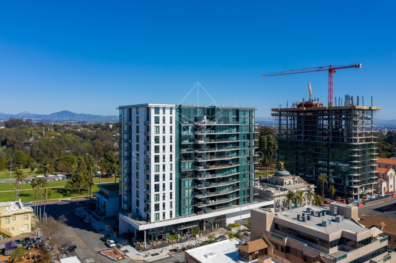 Aerial view of the downtown streets, palm trees and the buildings at Bankers Hill, with a work crew on site.