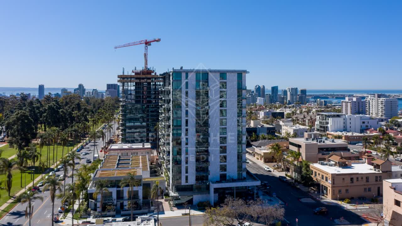 Aerial view of the downtown streets, the skyline and palm trees at Bankers Hill, with a work crew on site.
