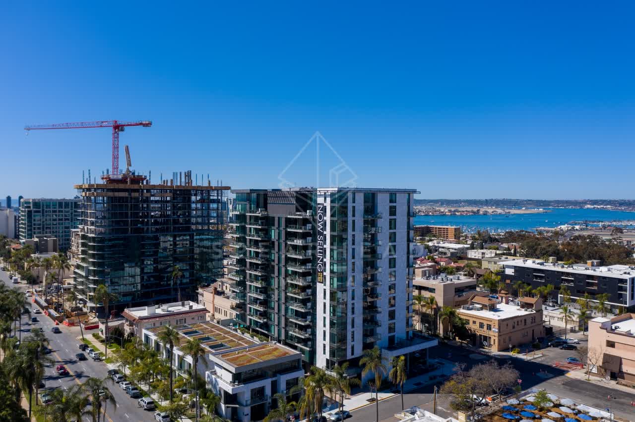 Aerial view of the downtown streets, palm trees and the bay at Bankers Hill, with a work crew on site.