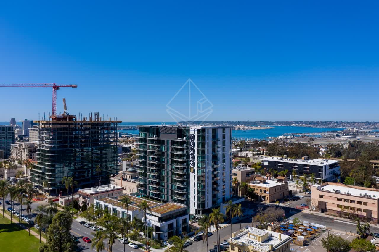 Aerial view of the downtown streets, palm trees and the bay at Bankers Hill, with a work crew on site.