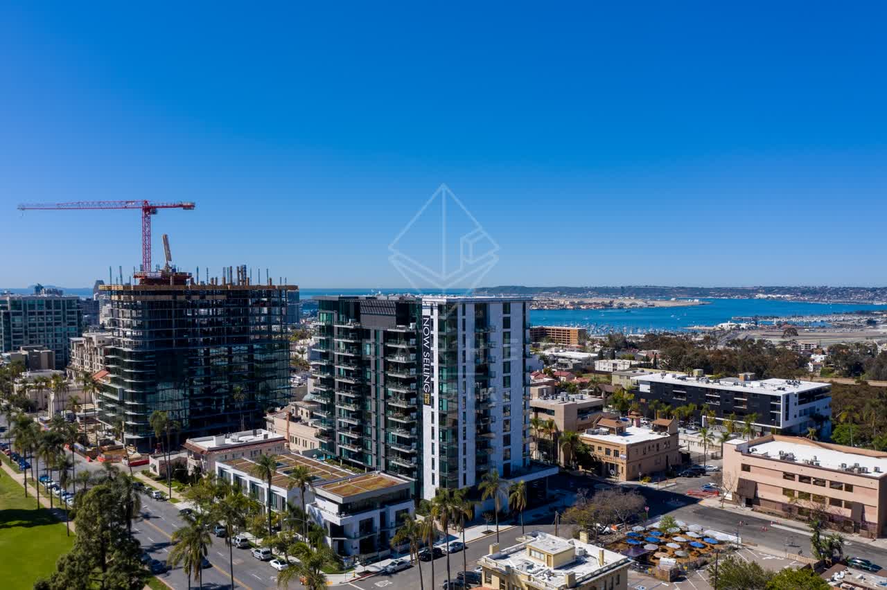 Aerial view of the downtown streets, the skyline and boats at Bankers Hill, with a work crew on site.