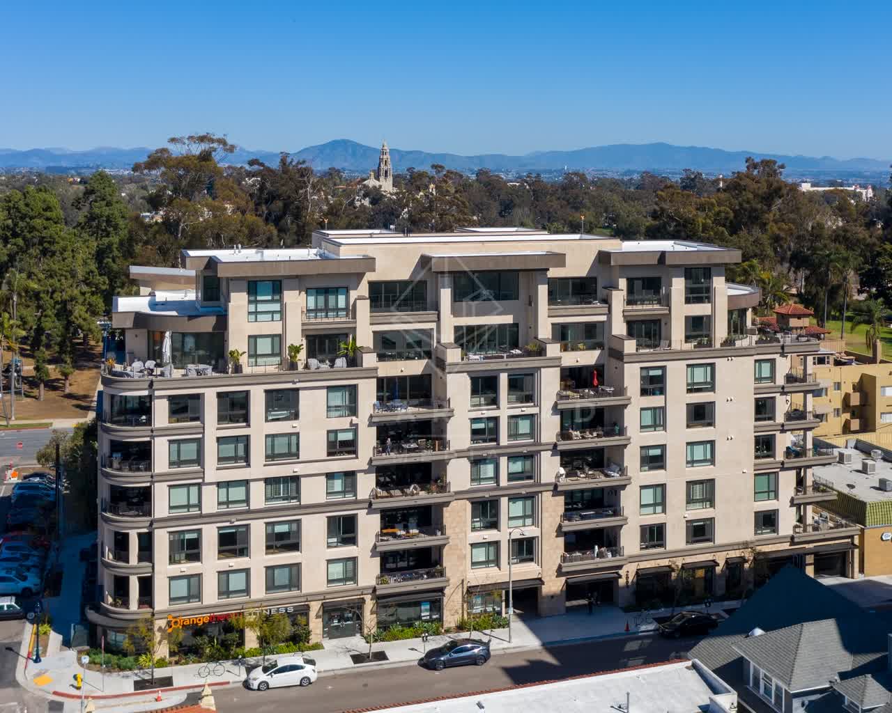 Low aerial view of a residential street, homes and the buildings at Bankers Hill.